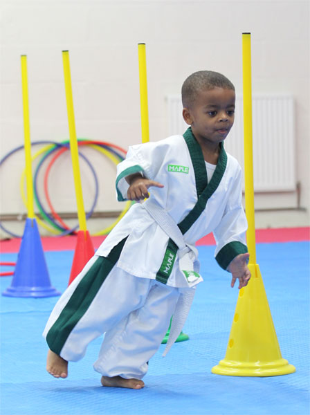 Student showing the Fundamental Movement Skills for Physical Literacy in a childrens martial arts programme