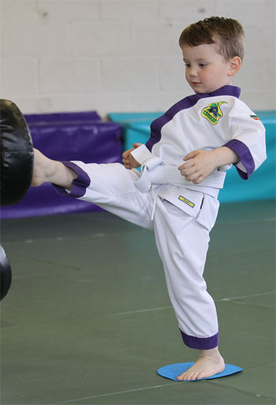Martial Arts child showing the mastery part of self determination theory